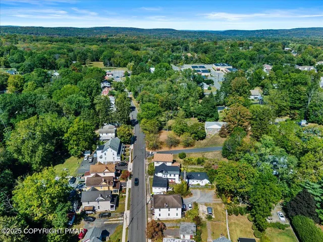 a living room with furniture a dining table and kitchen view