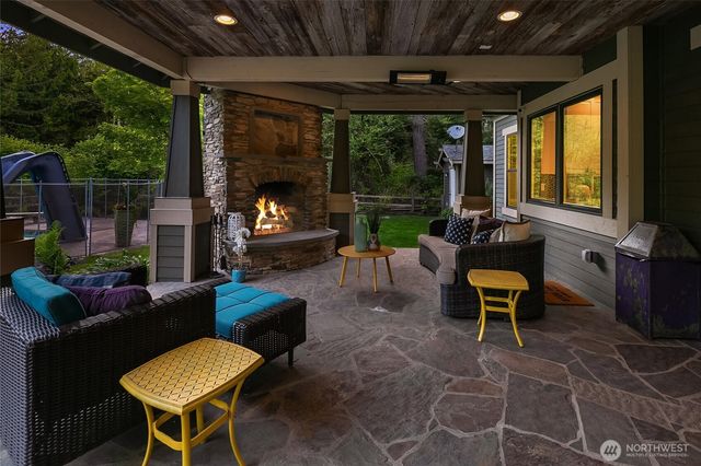 a living room with patio fireplace furniture and a potted plants
