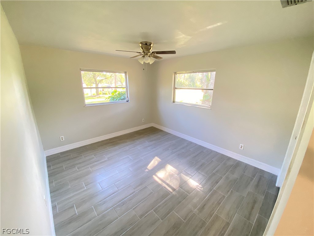 17890 Leetana Road North Fort Myers, FL 33917 - Photo 20 of 25 a view of empty room with wooden floor and fan