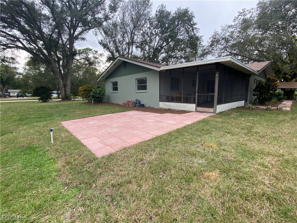 17890 Leetana Road North Fort Myers, FL 33917 - Photo 2 of 25 a view of a house with a yard and garage