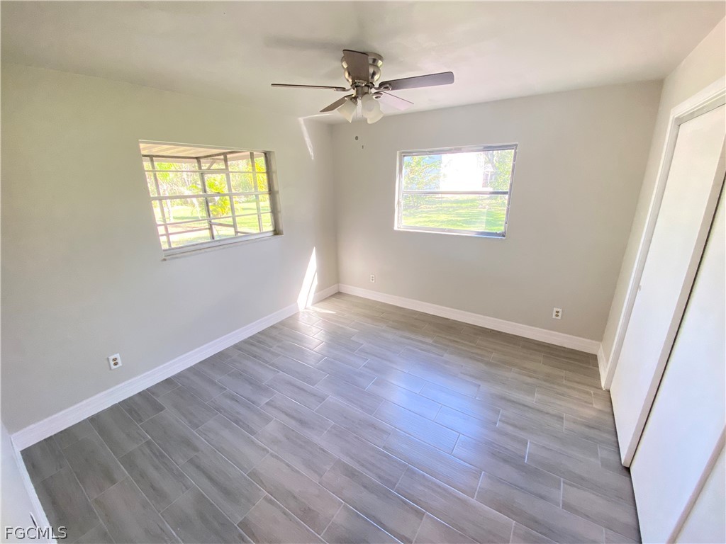 17890 Leetana Road North Fort Myers, FL 33917 - Photo 22 of 25 wooden floor in an empty room with a window