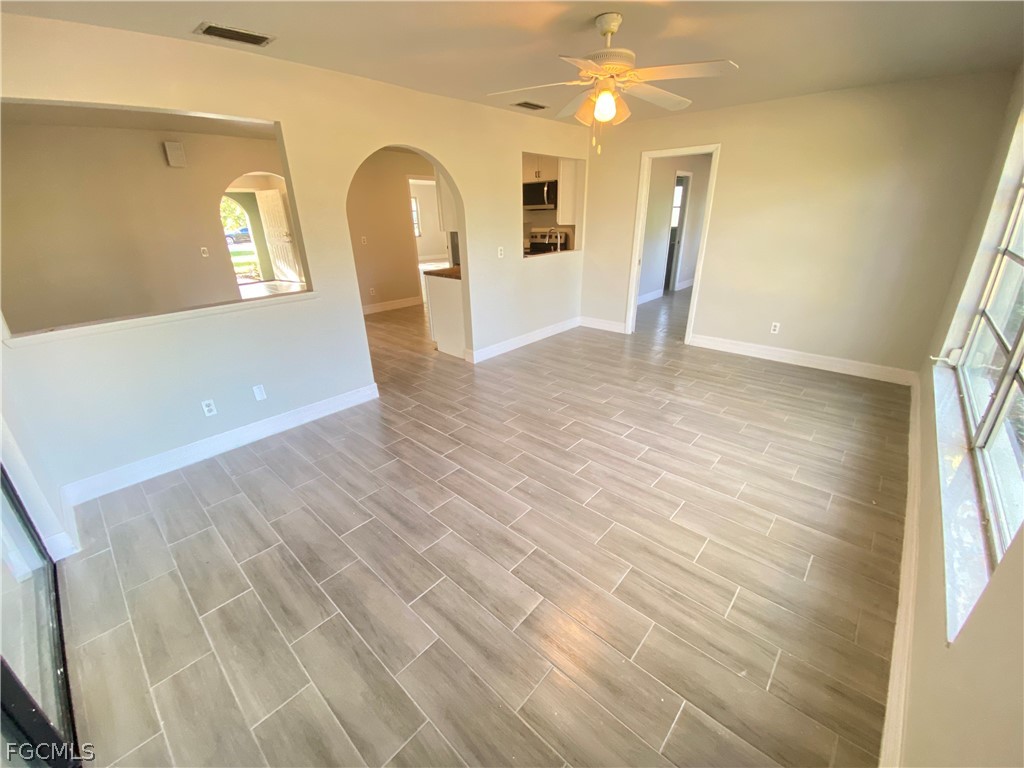 17890 Leetana Road North Fort Myers, FL 33917 - Photo 3 of 25 a view of a big room with wooden floor and windows