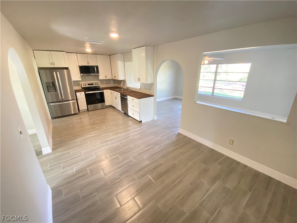 17890 Leetana Road North Fort Myers, FL 33917 - Photo 6 of 25 a view of kitchen with sink microwave refrigerator and cabinets