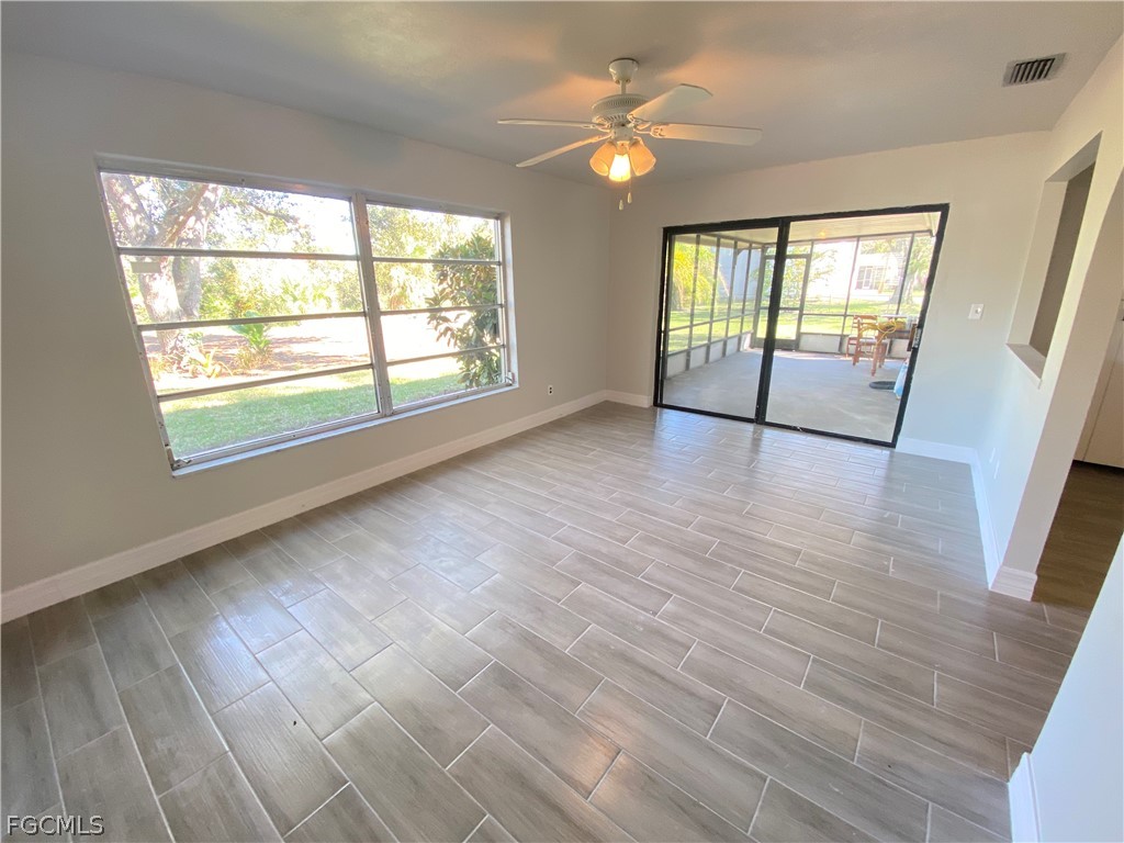 17890 Leetana Road North Fort Myers, FL 33917 - Photo 8 of 25 an empty room with wooden floor and windows