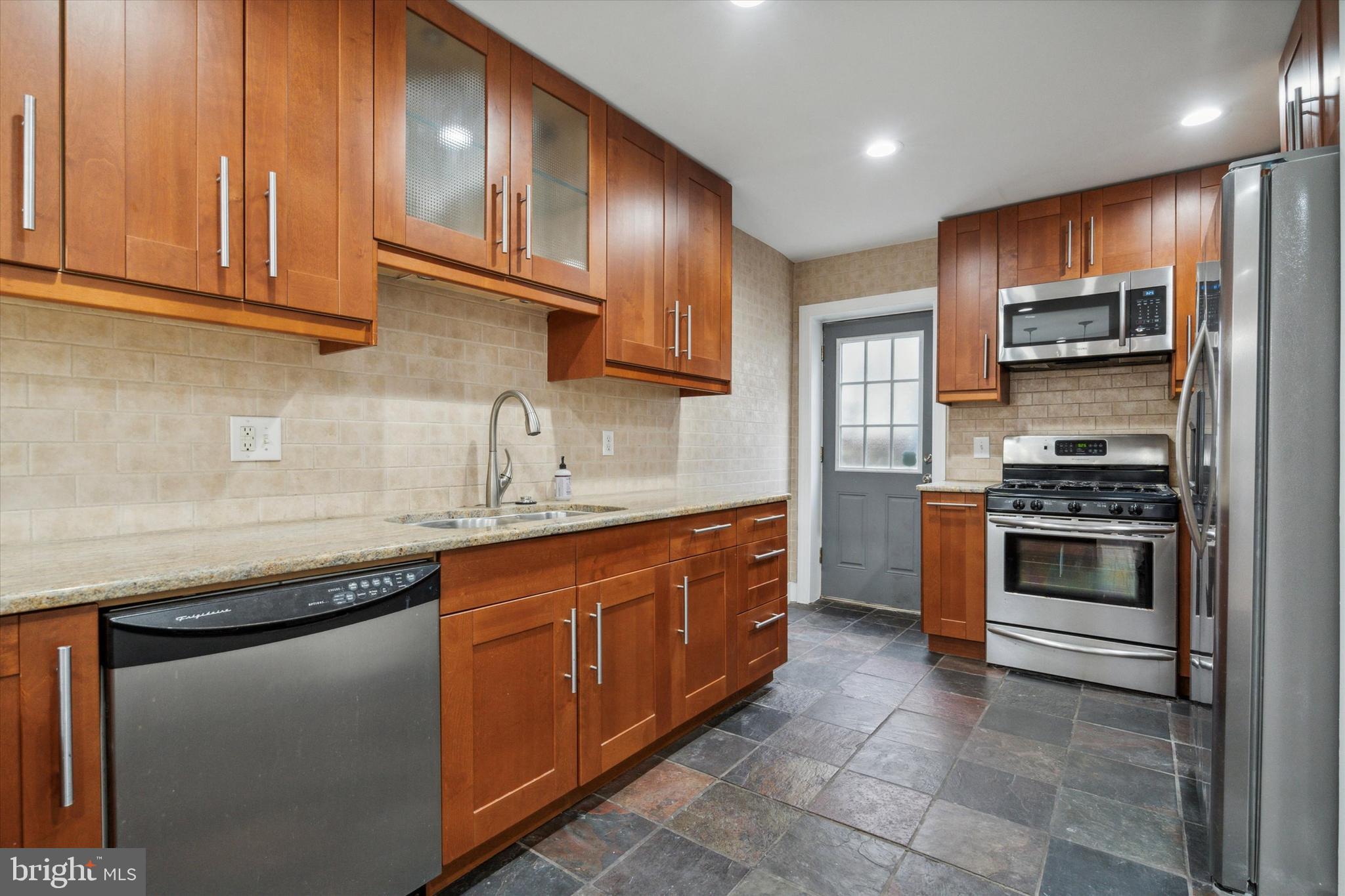 711 Reed Street Philadelphia, PA 19147 - Photo 11 of 32 a kitchen with stainless steel appliances granite countertop a sink and cabinets