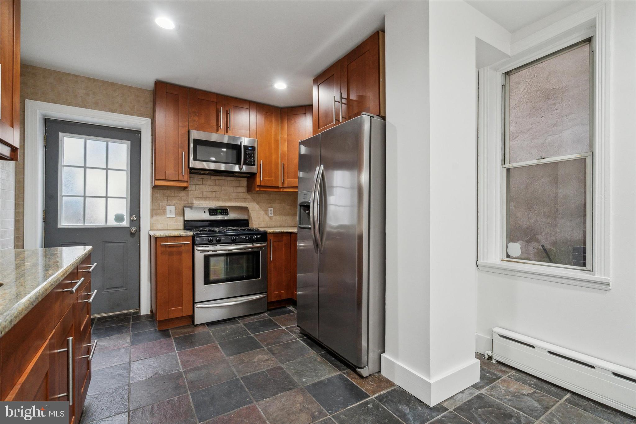 711 Reed Street Philadelphia, PA 19147 - Photo 12 of 32 a kitchen with stainless steel appliances granite countertop a refrigerator and a stove top oven