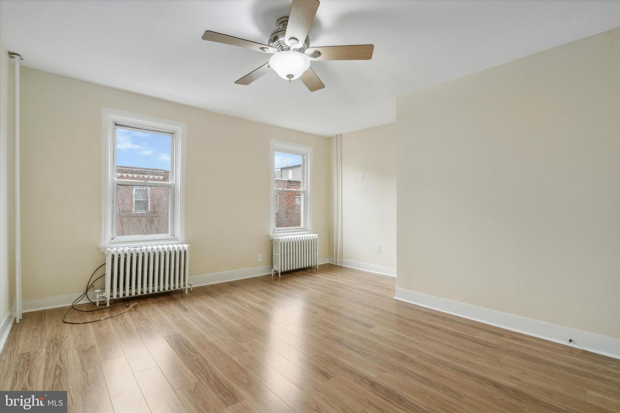 711 Reed Street Philadelphia, PA 19147 - Photo 17 of 32 an empty room with wooden floor and windows