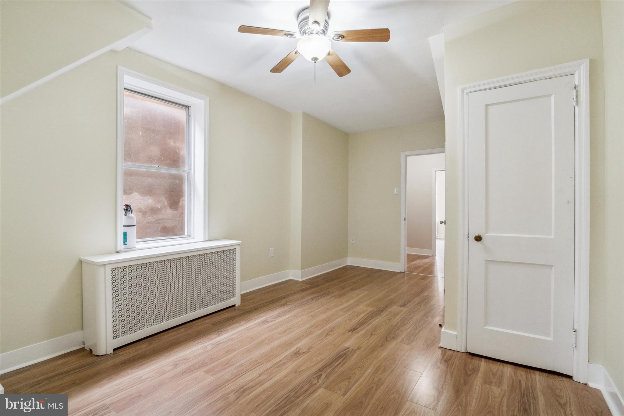711 Reed Street Philadelphia, PA 19147 - Photo 21 of 32 a view of an empty room with window and wooden floor