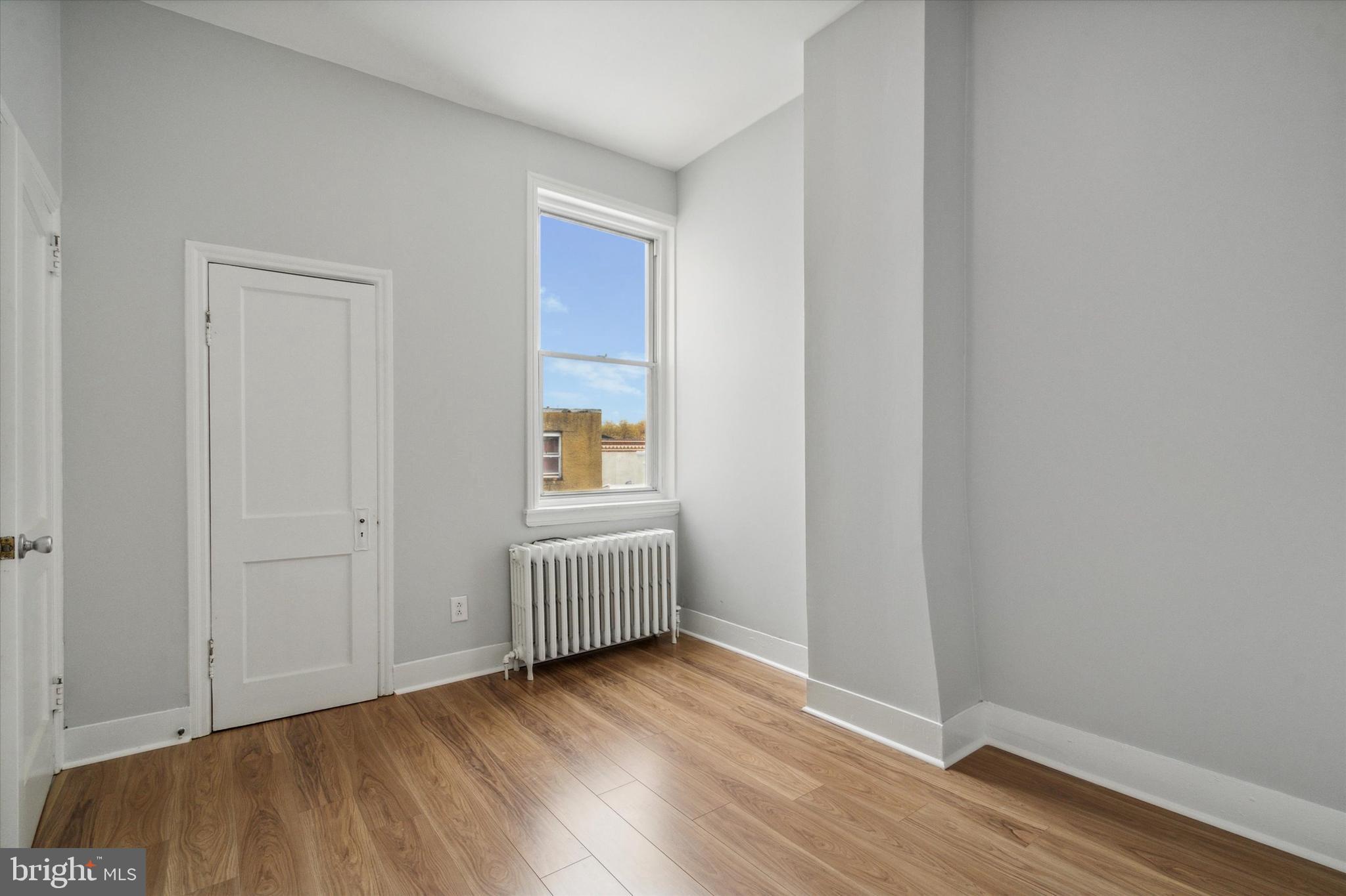 711 Reed Street Philadelphia, PA 19147 - Photo 27 of 32 an empty room with wooden floor and windows