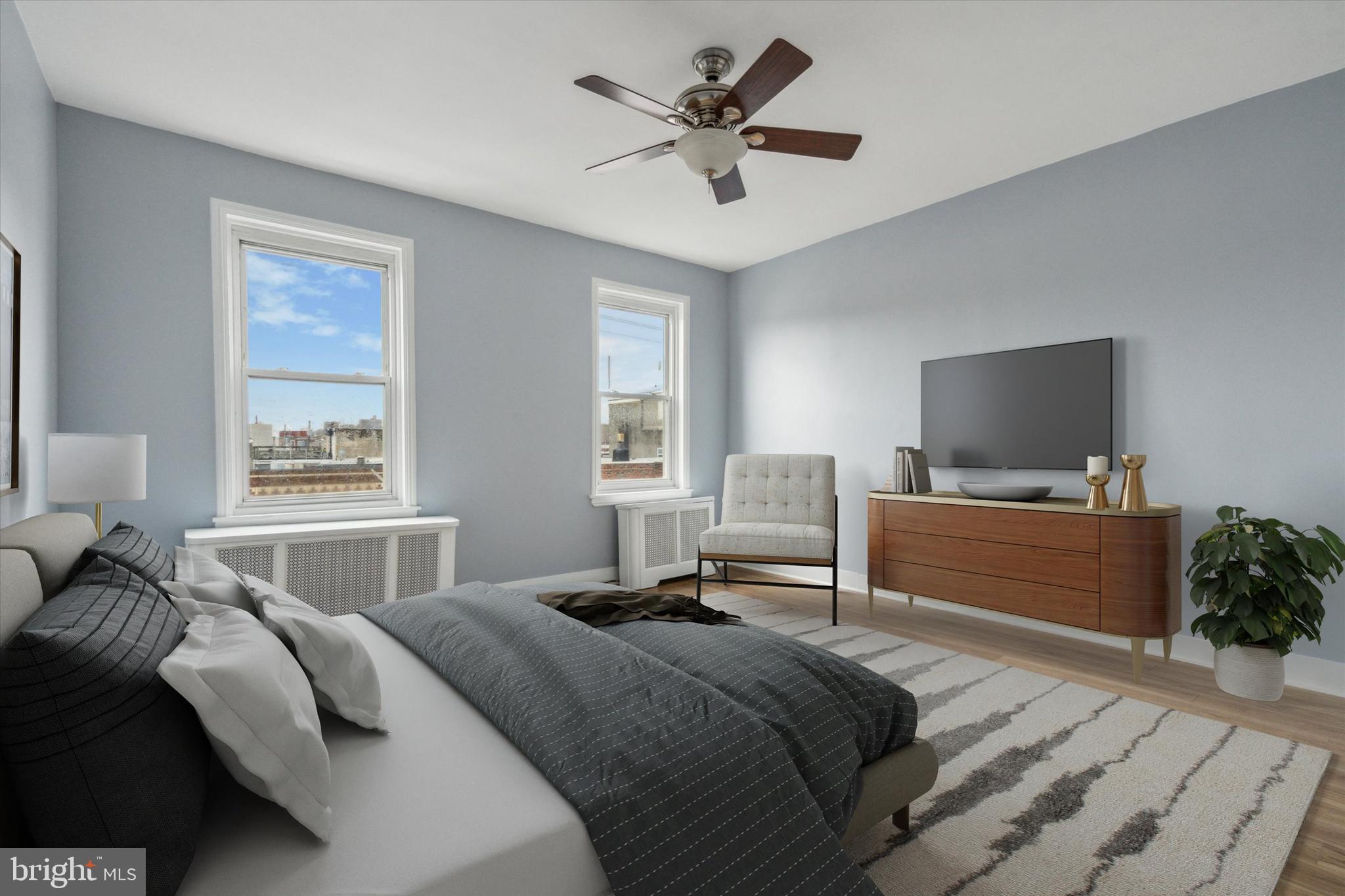 711 Reed Street Philadelphia, PA 19147 - Photo 30 of 32 a bedroom with a bed and a flat screen tv