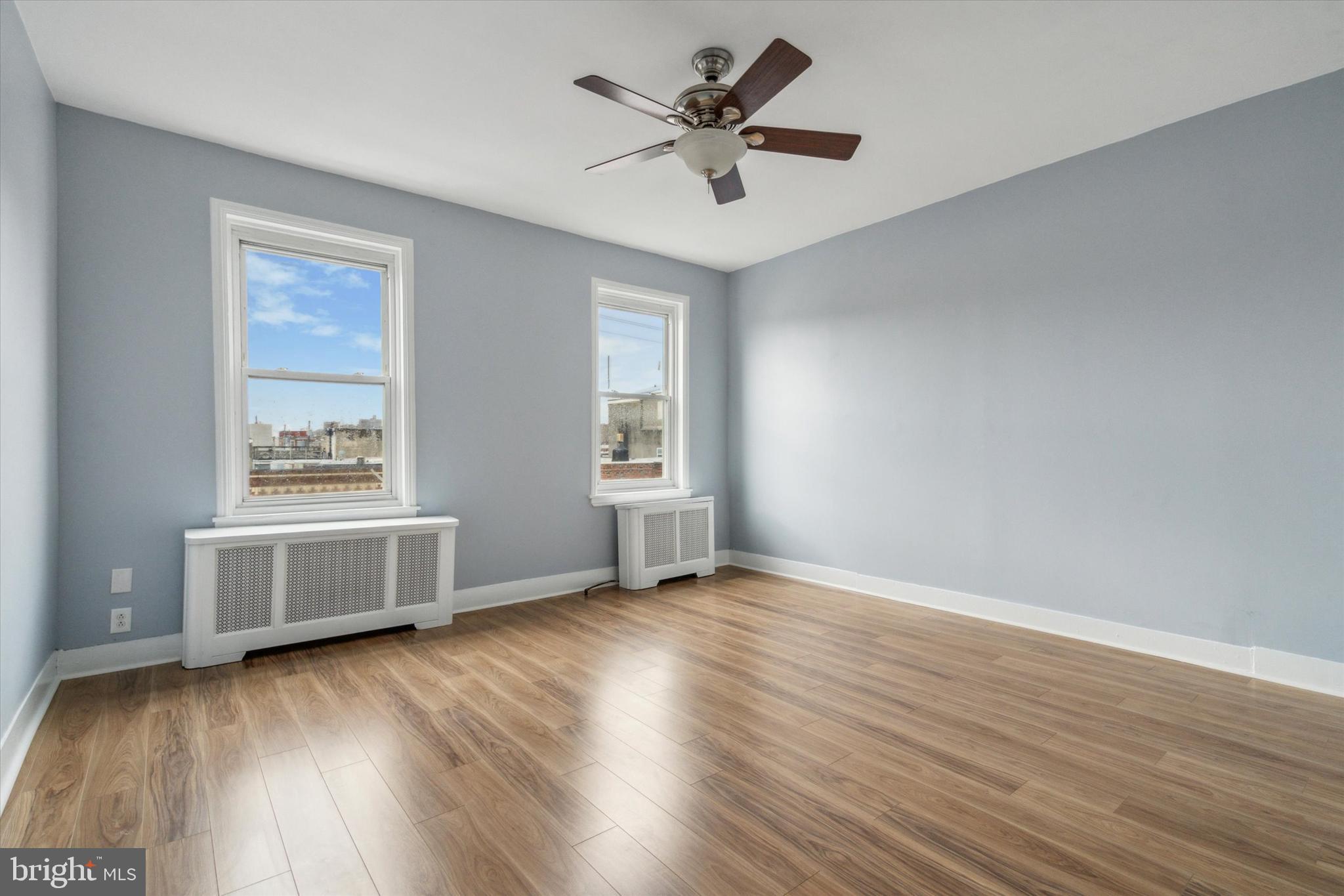 711 Reed Street Philadelphia, PA 19147 - Photo 31 of 32 an empty room with wooden floor and windows