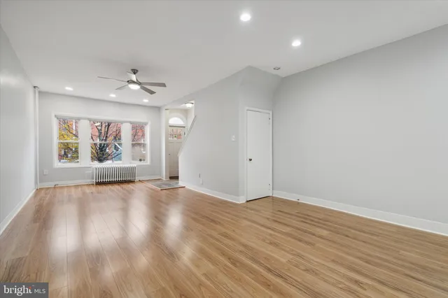 wooden floor in an empty room with a window