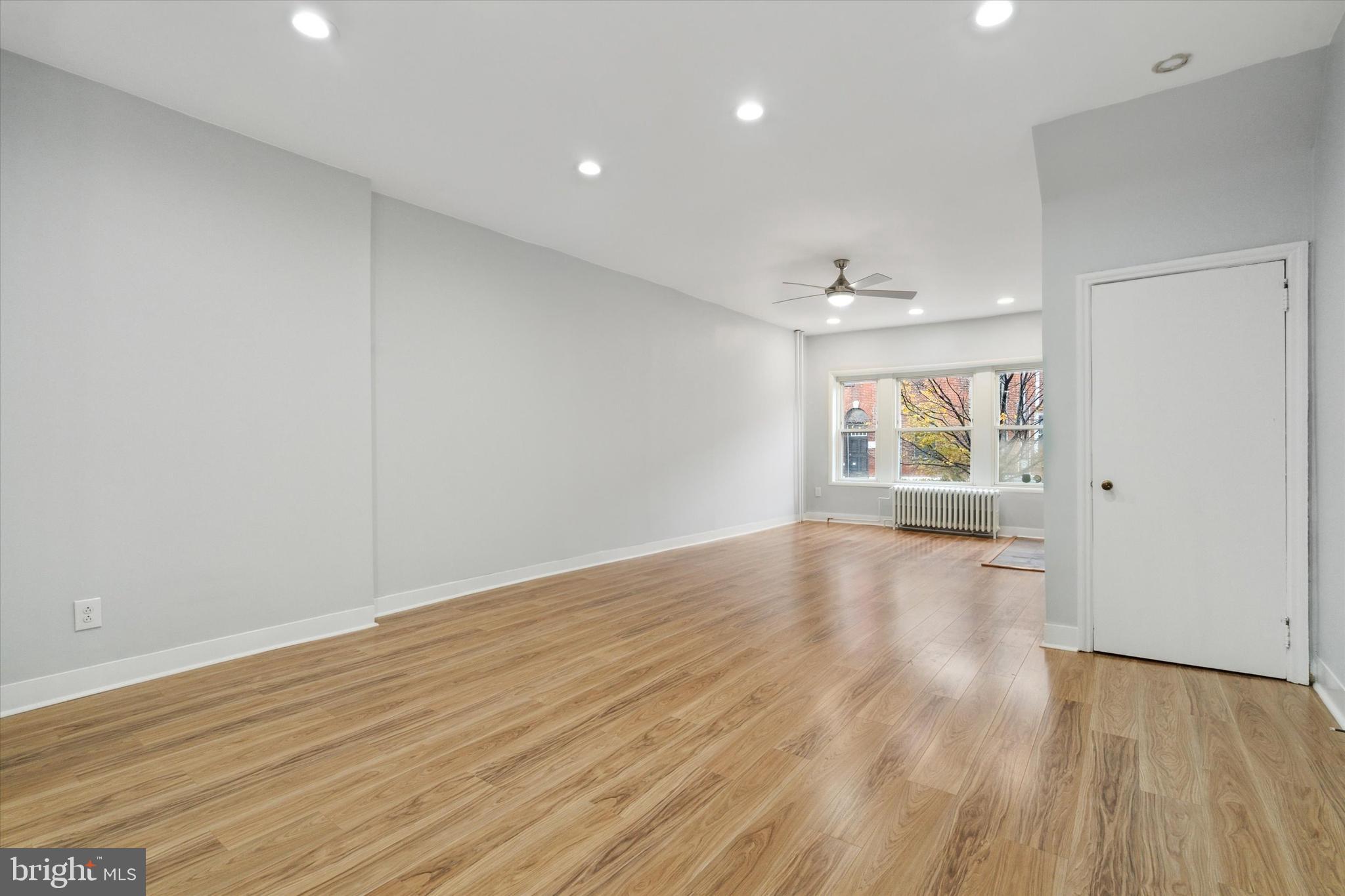 711 Reed Street Philadelphia, PA 19147 - Photo 9 of 32 an empty room with wooden floor and windows