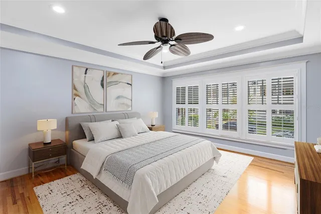 a bedroom with a large bed and a large window