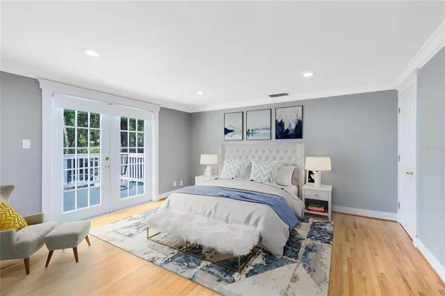 a bedroom with a bed and wooden floor