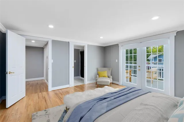a bedroom with a bed and wooden floor