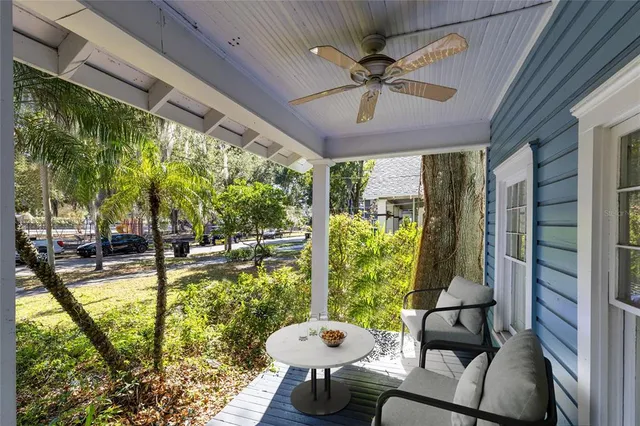a living room with a floor to ceiling window and a table