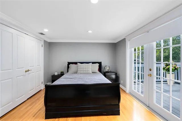 a bedroom with a bed and a night stand