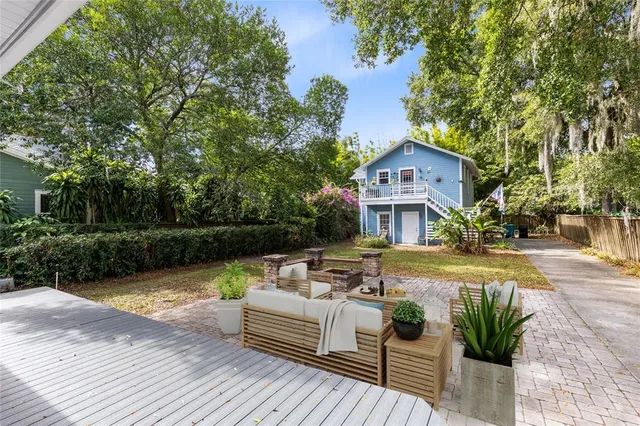 a view of a house with garden and a trees