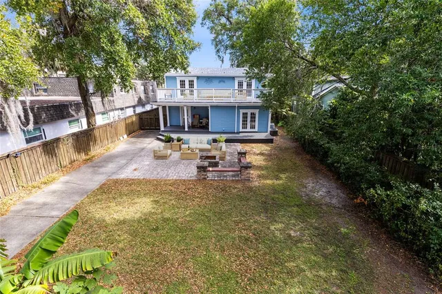 a view of a house with pool and sitting area