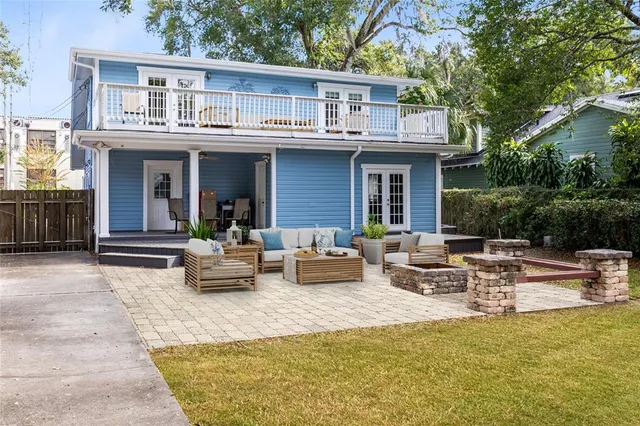 a view of a patio with couches table and chairs and potted plants