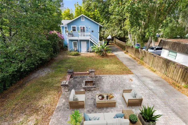 a view of a house with backyard porch and sitting area