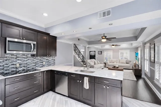 a kitchen with a sink stove and microwave