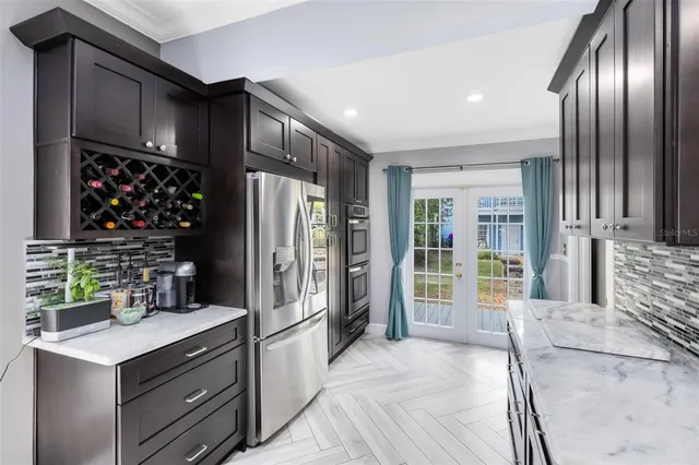 a kitchen with granite countertop stainless steel appliances and a refrigerator