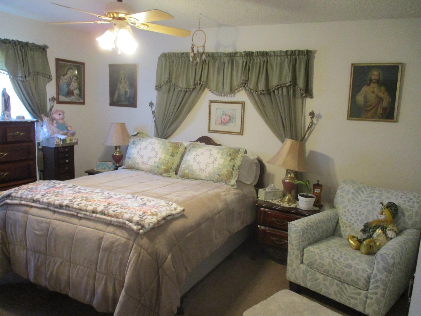 467 Tuttle Avenue Watsonville, CA 95076 - Photo 2 of 7 a bedroom with a bed and mirror