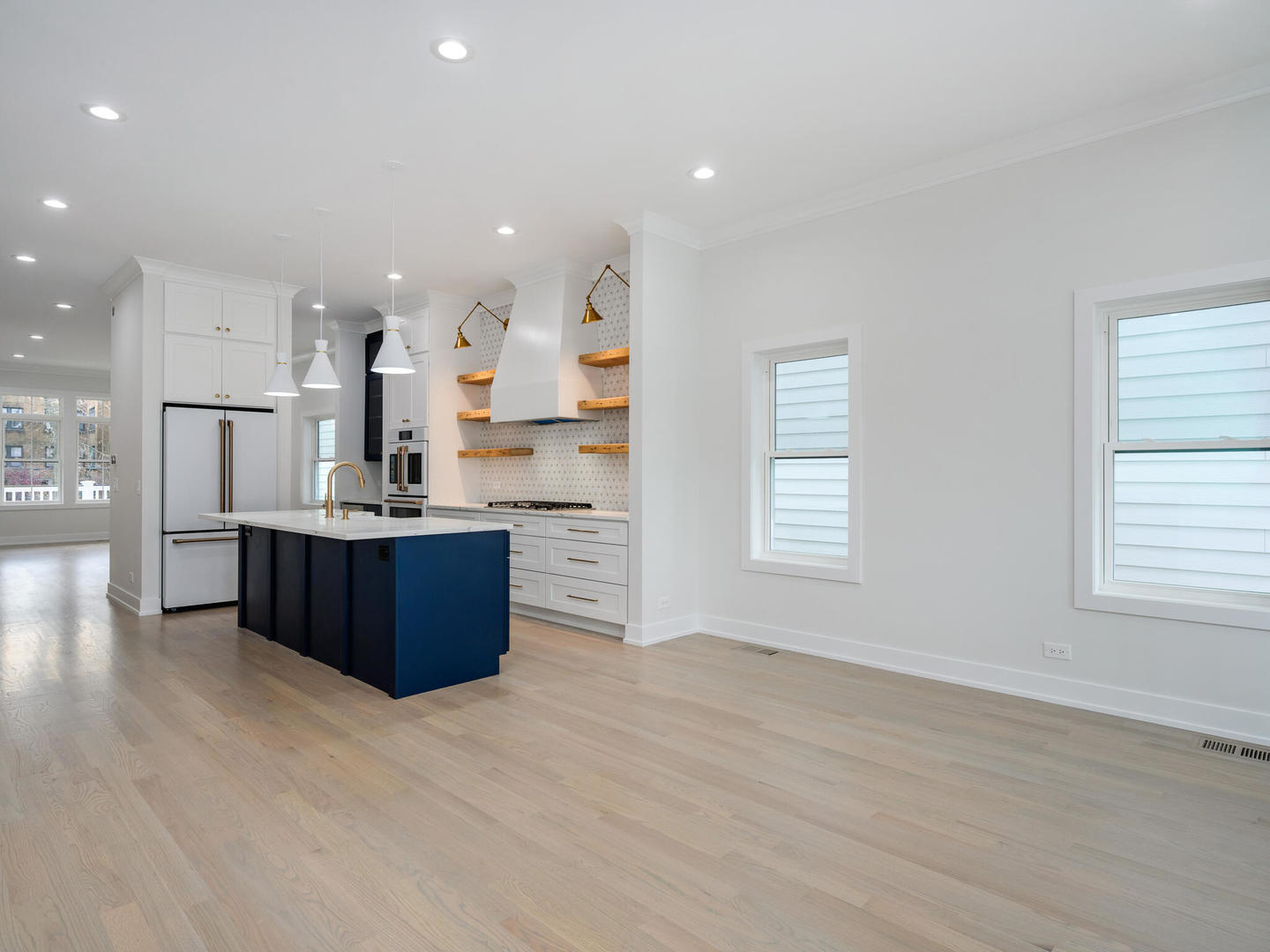 Undisclosed Address Chicago, IL 60618 - Photo 11 of 28 a kitchen with stainless steel appliances kitchen island granite countertop a refrigerator a sink dishwasher and a stove with wooden floors
