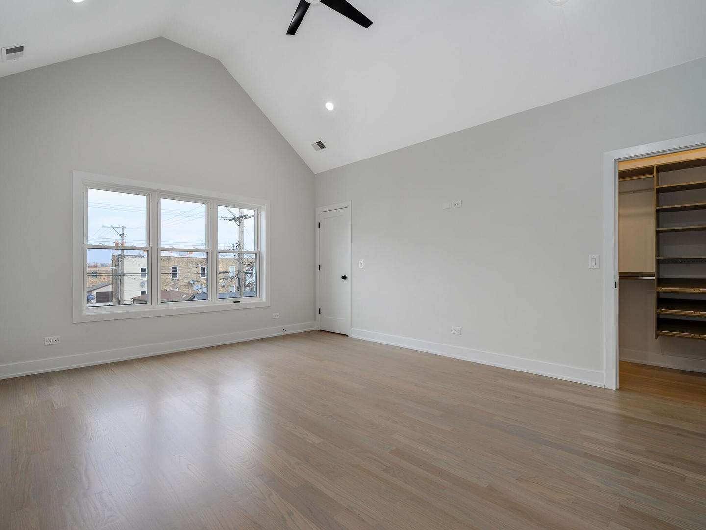 Undisclosed Address Chicago, IL 60618 - Photo 14 of 28 an empty room with wooden floor and windows