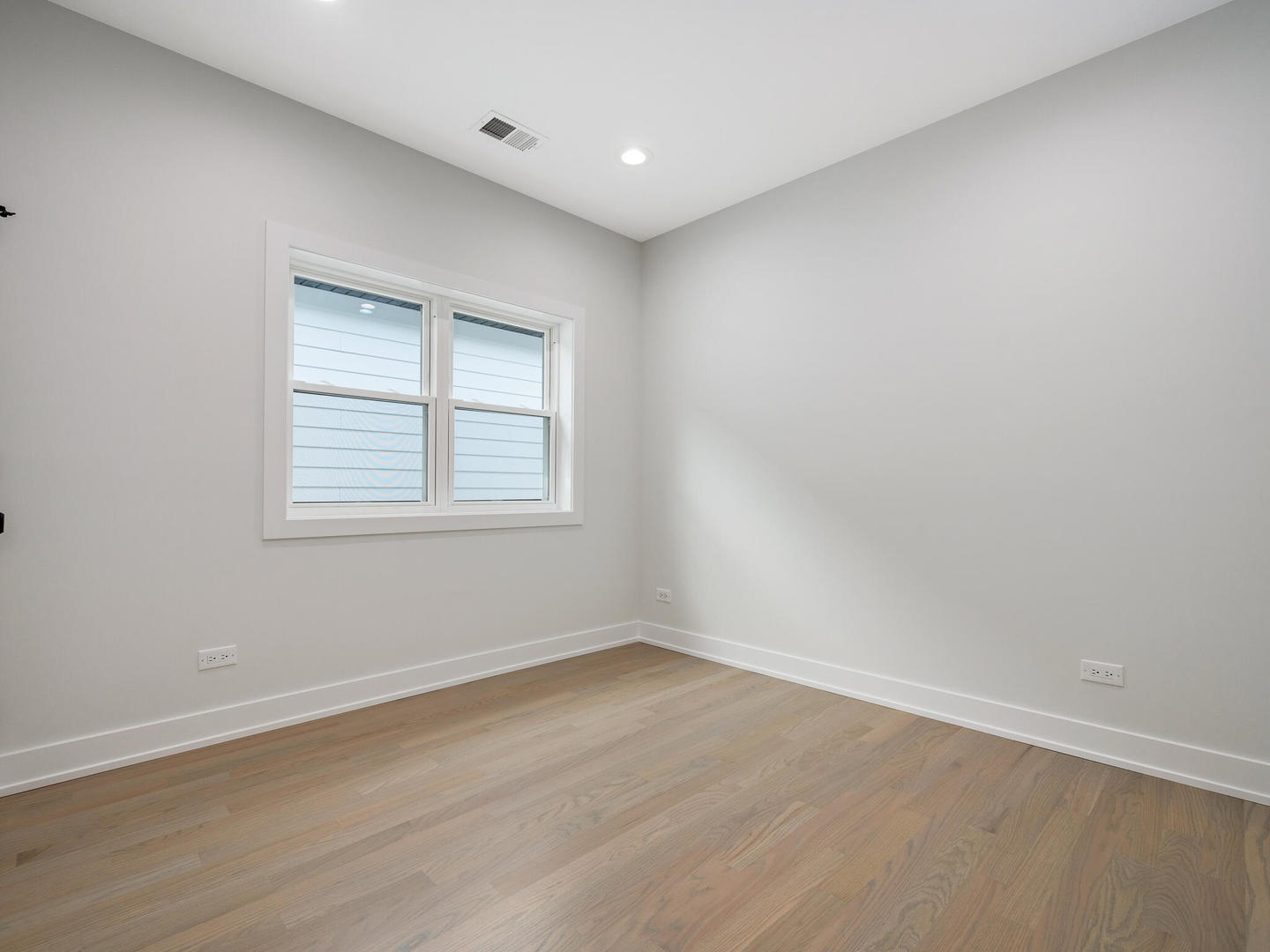 Undisclosed Address Chicago, IL 60618 - Photo 19 of 28 wooden floor in an empty room with a window