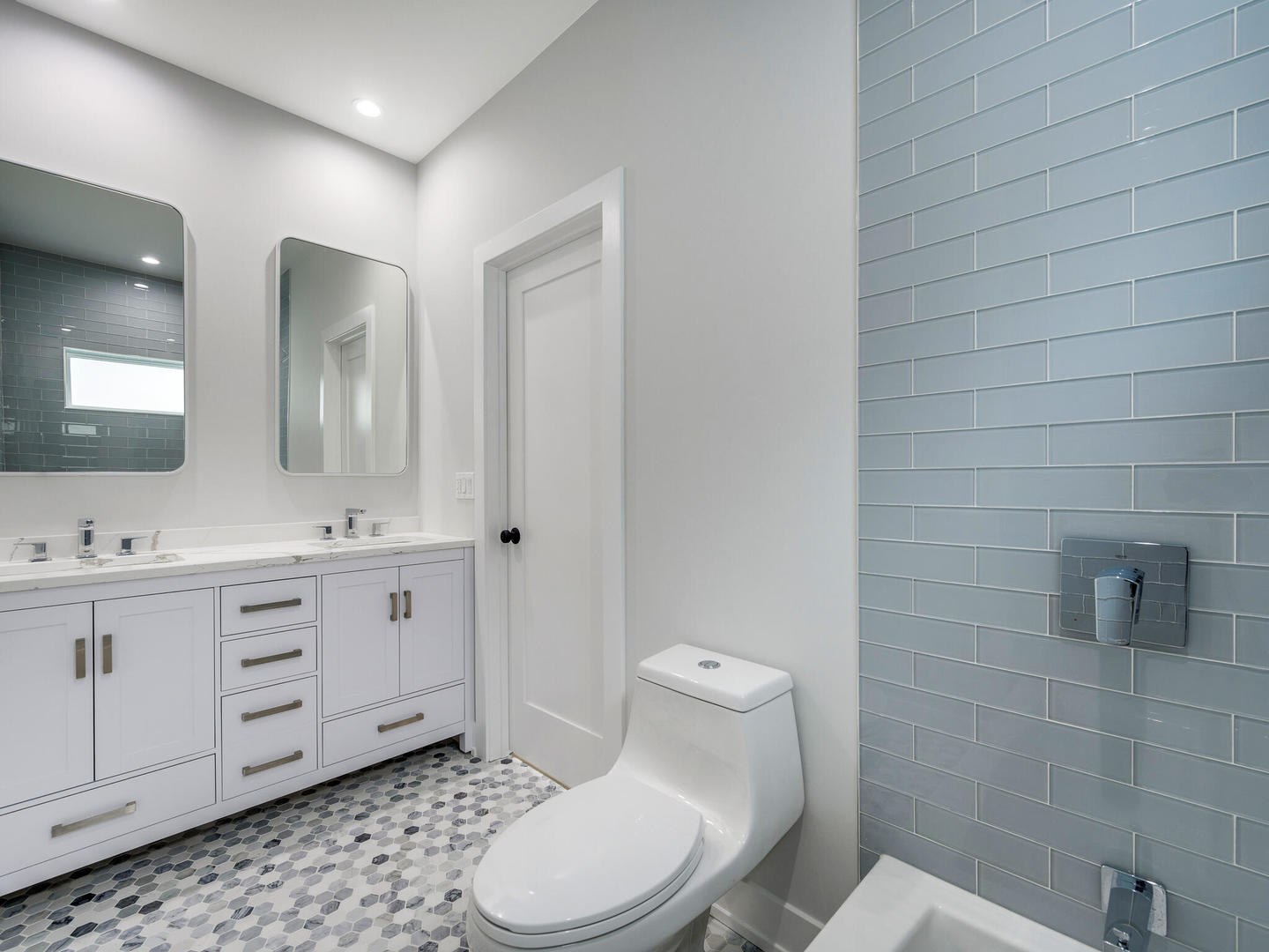 Undisclosed Address Chicago, IL 60618 - Photo 20 of 28 a bathroom with a toilet a sink a mirror a window and vanity