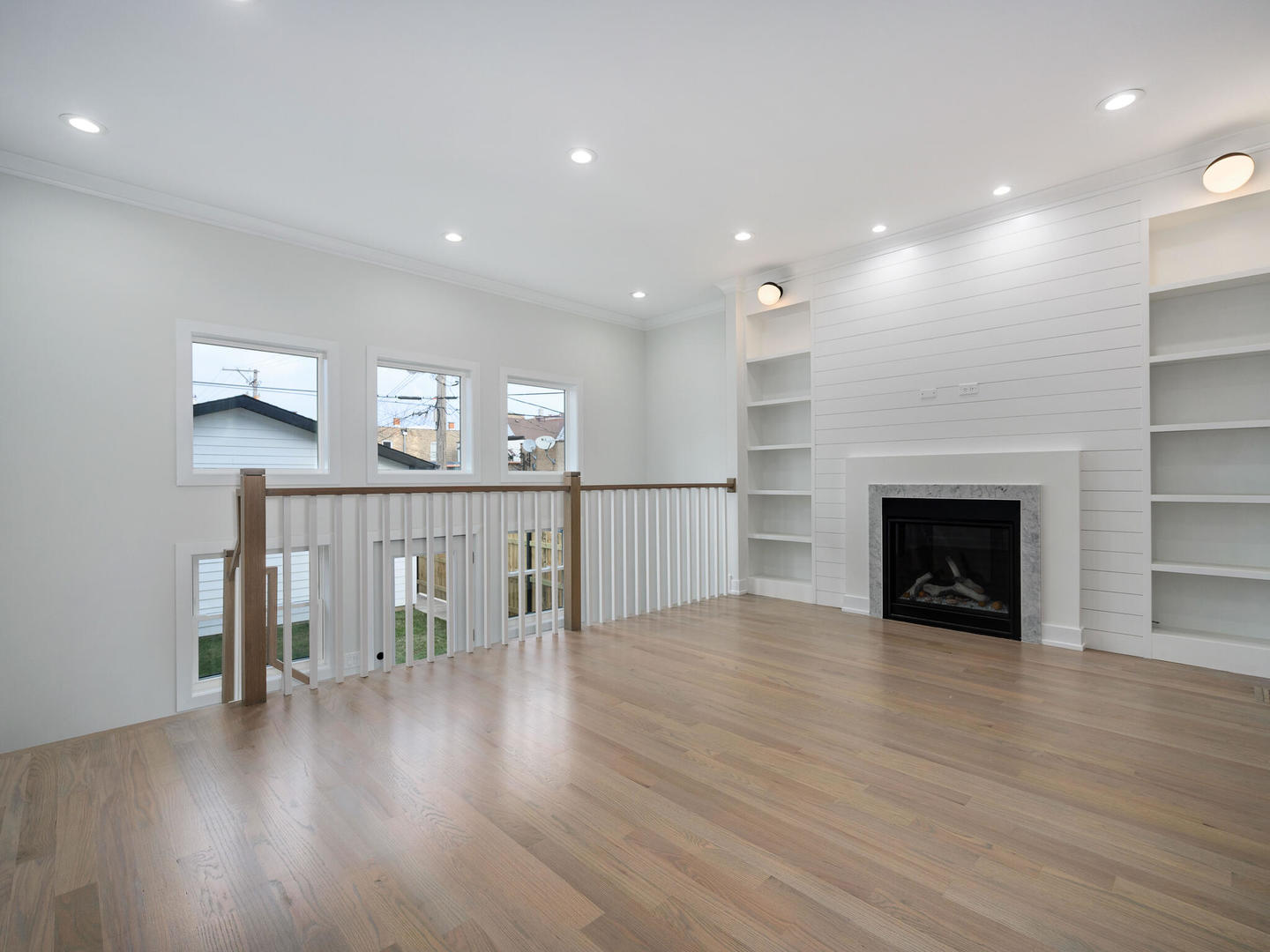 Undisclosed Address Chicago, IL 60618 - Photo 9 of 28 a view of an empty room with wooden floor and a fireplace