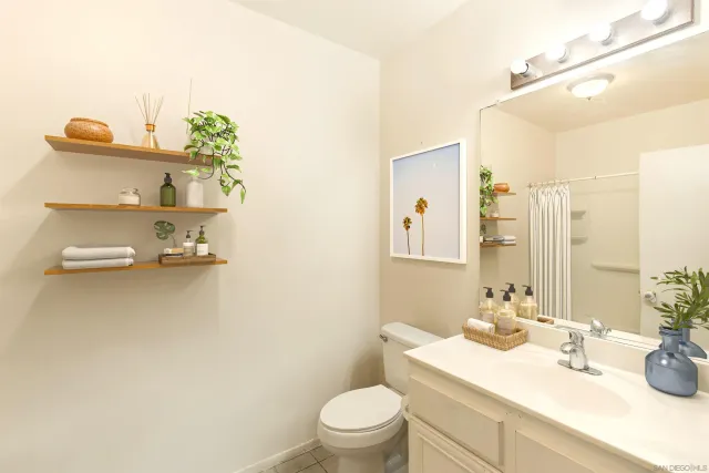 a bathroom with a sink a toilet and mirror