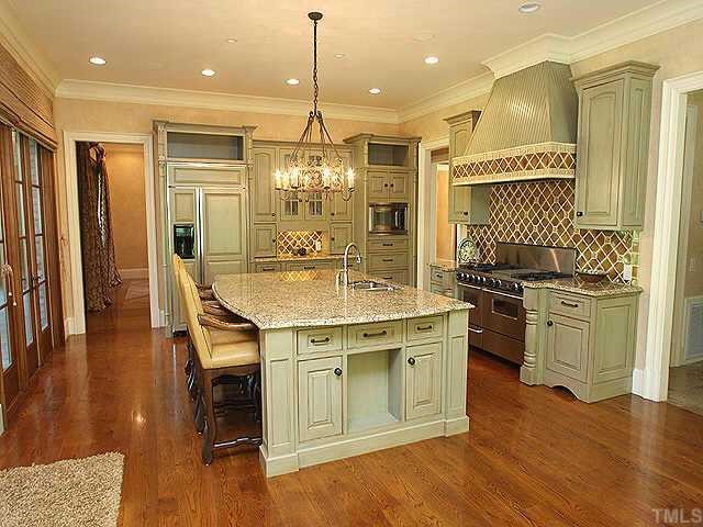 1059 Grayson Road Creedmoor, NC 27522 - Photo 2 of 12 HUGE Gourmet Kitchen with Granite Counters, SS Appliances, Tile Backsplash, Large Center Island, & Extensive Trim.
