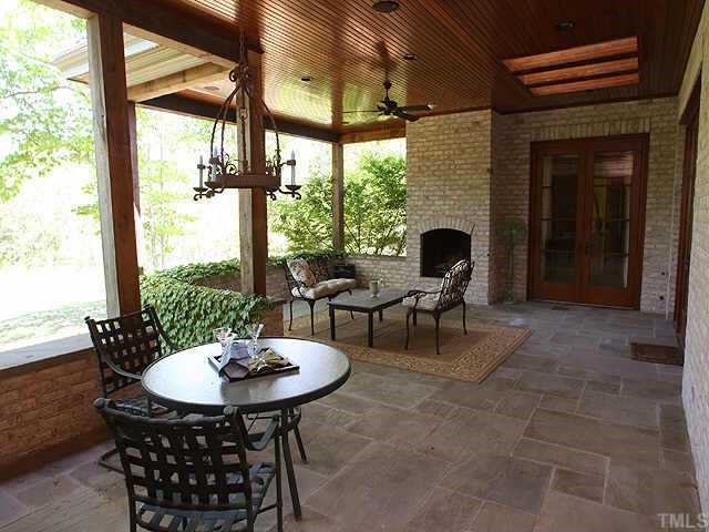 1059 Grayson Road Creedmoor, NC 27522 - Photo 9 of 12 Covered Porch with Custom Wood Trim, Skylights & Fireplace overlook Dramatic Views of Backyard/Play Area!