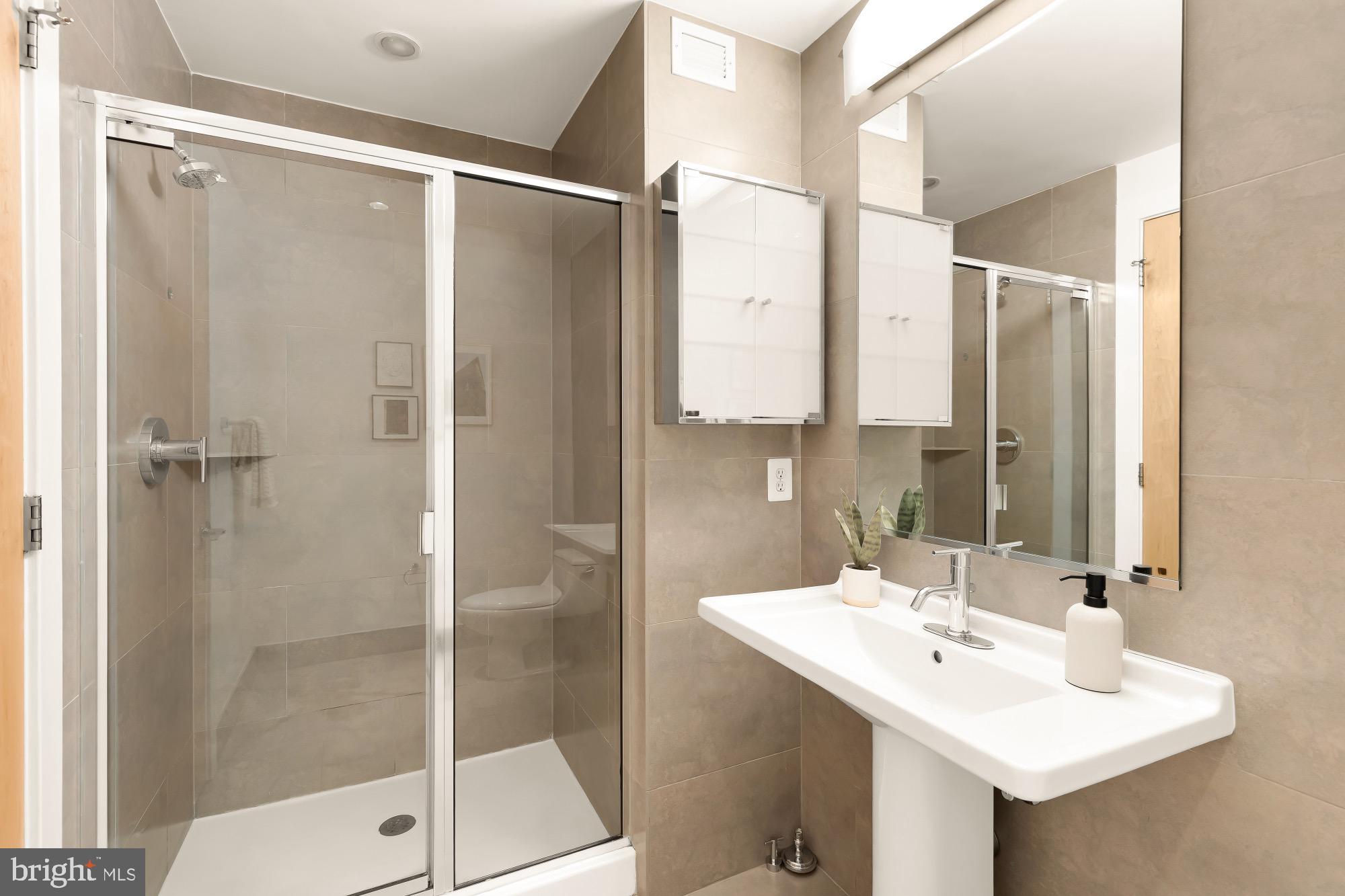 1133 14th Street Northwest, Unit 308 Washington, DC 20005 - Photo 16 of 34 Sleek modern bathroom with elegant finishes.