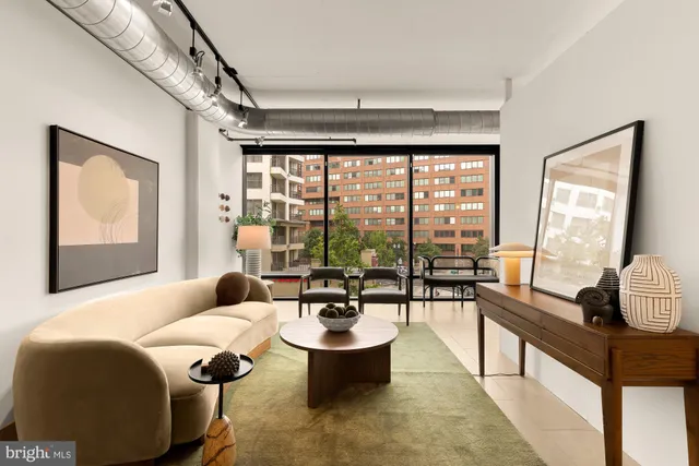 a living room with furniture and floor to ceiling window