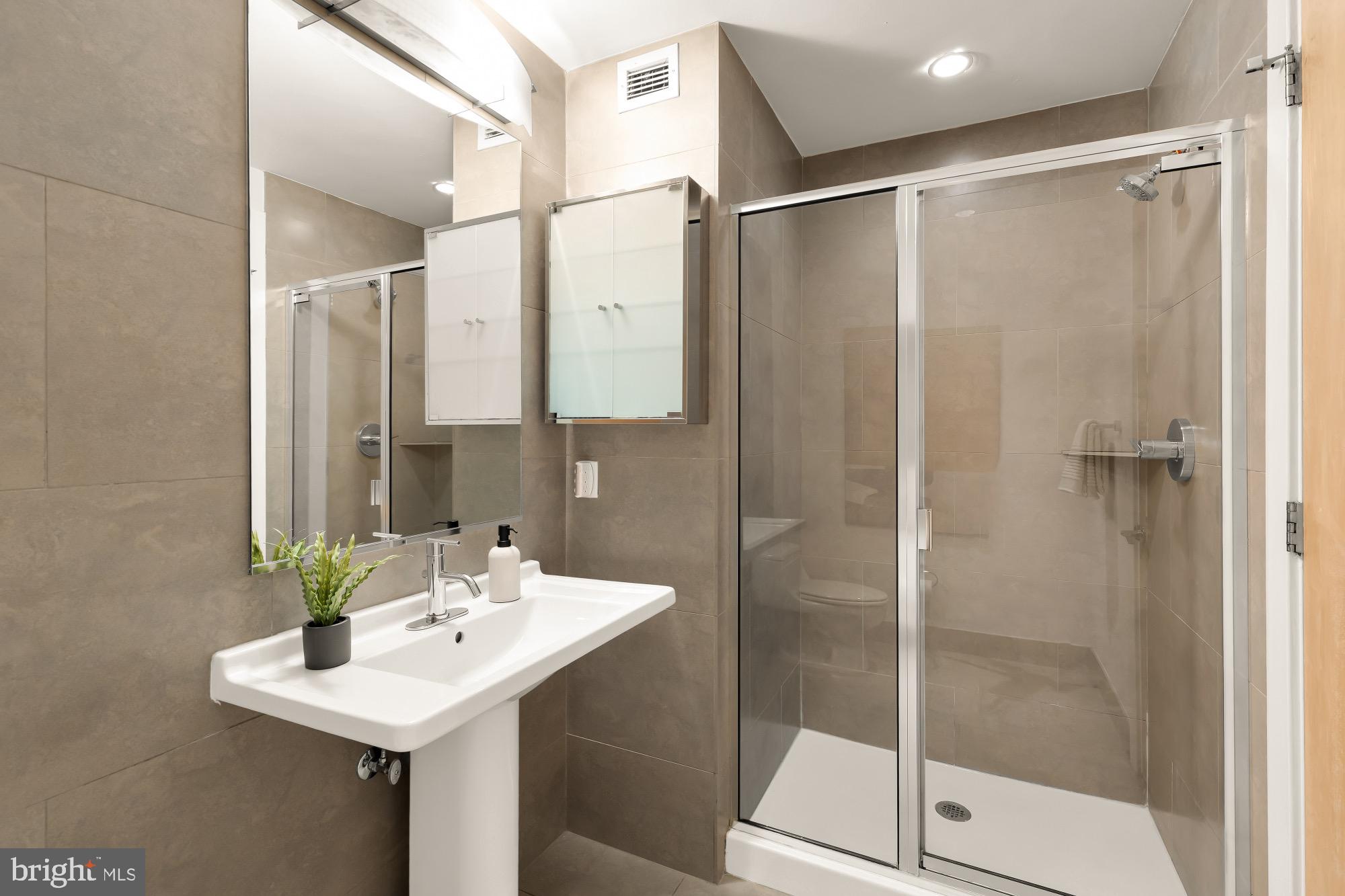 1133 14th Street Northwest, Unit 308 Washington, DC 20005 - Photo 22 of 34 Sleek modern bathroom with elegant finishes.