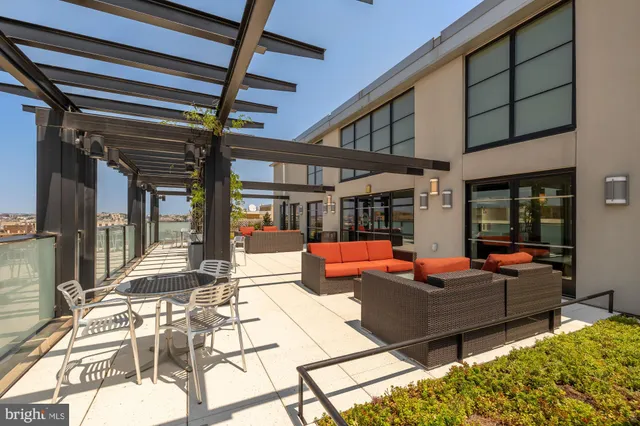a outdoor view of a patio with dining table and chairs with wooden floor