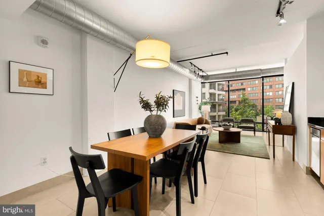 a dining room with furniture and wooden floor