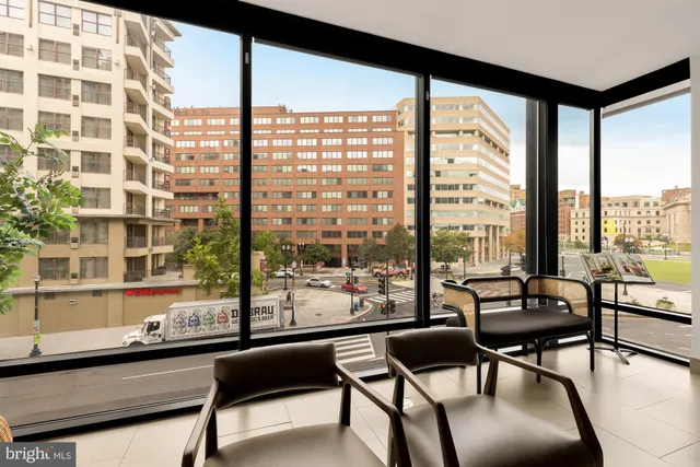a living room with furniture and a floor to ceiling window