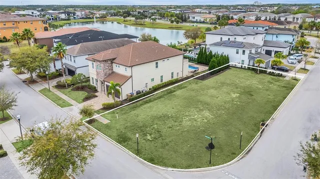 an aerial view of residential houses with outdoor space and river