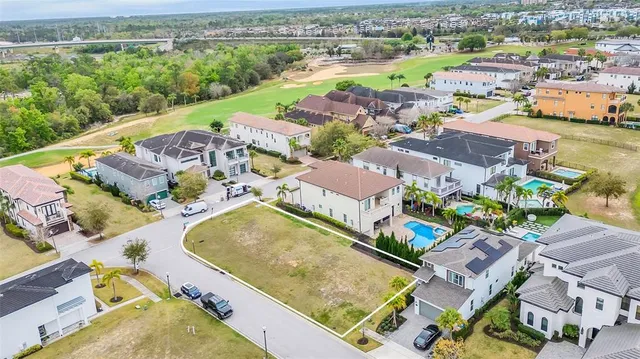 an aerial view of residential houses with outdoor space and parking
