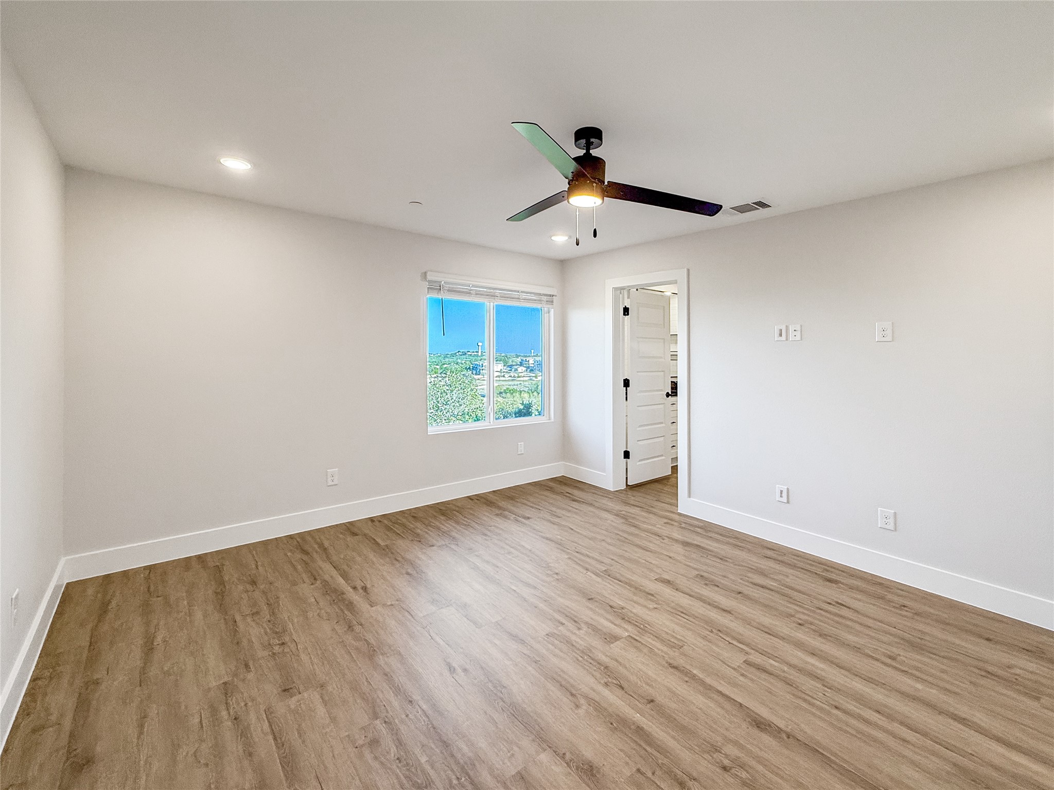 5611 Mobeetie Loop Bee Cave, TX 78738 - Photo 15 of 22 wooden floor in an empty room with a window