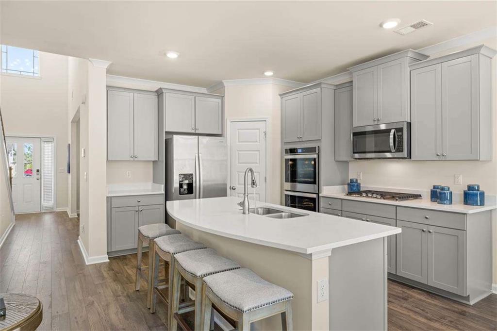 13632 Whitman Lane Covington, GA 30014 - Photo 11 of 53 a kitchen with a refrigerator a stove microwave and cabinets