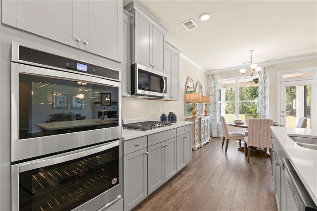 13632 Whitman Lane Covington, GA 30014 - Photo 15 of 53 a kitchen with stainless steel appliances a stove a sink and a microwave