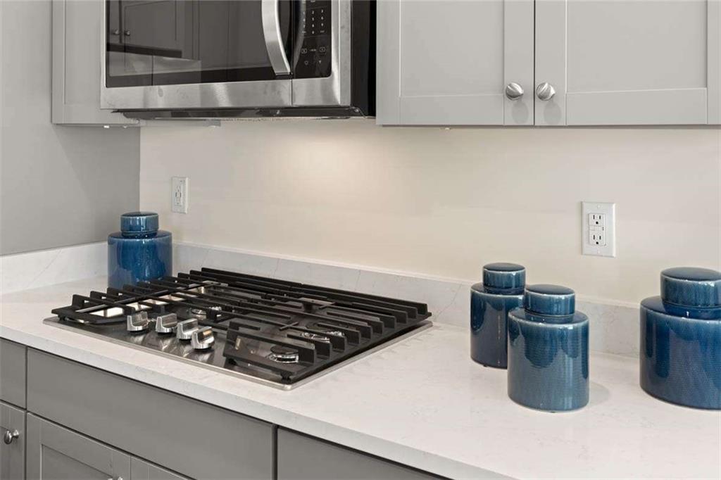 13632 Whitman Lane Covington, GA 30014 - Photo 16 of 53 a kitchen with a stove and a microwave