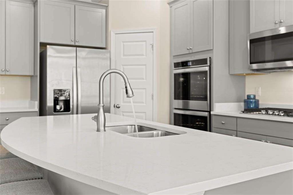 13632 Whitman Lane Covington, GA 30014 - Photo 17 of 53 a kitchen with stainless steel appliances a microwave a sink a stove and refrigerator